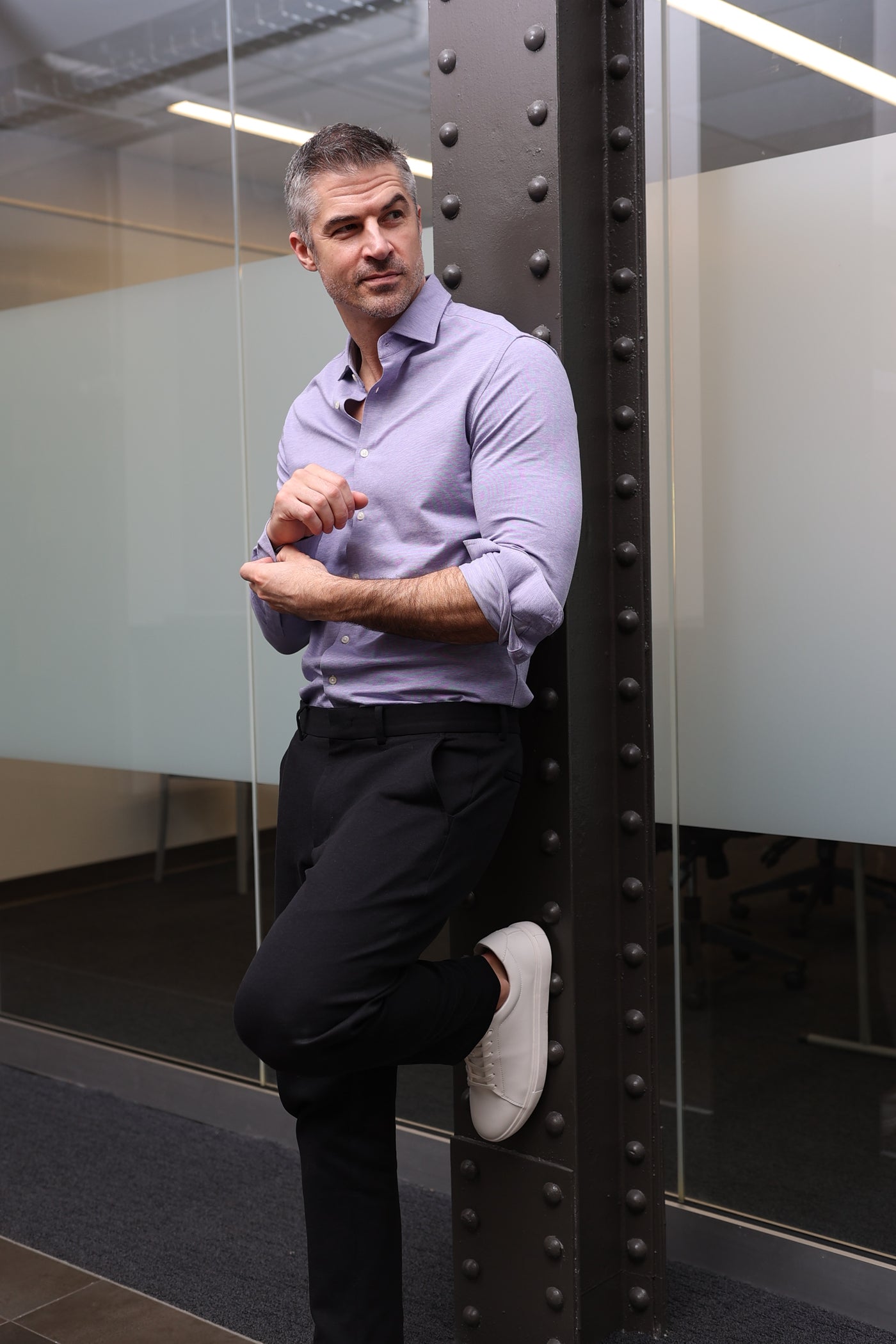 man dressed in nice clothing in modern office setting